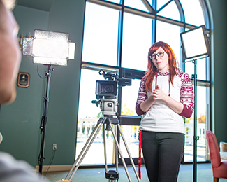 student with video camera equipment