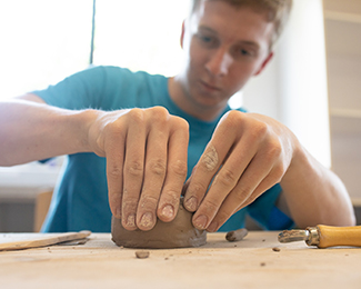 Students drawing at an easel