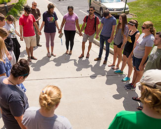 students praying in a circl