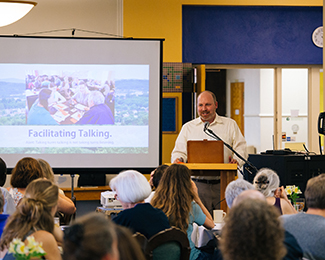 person in speaking to a group